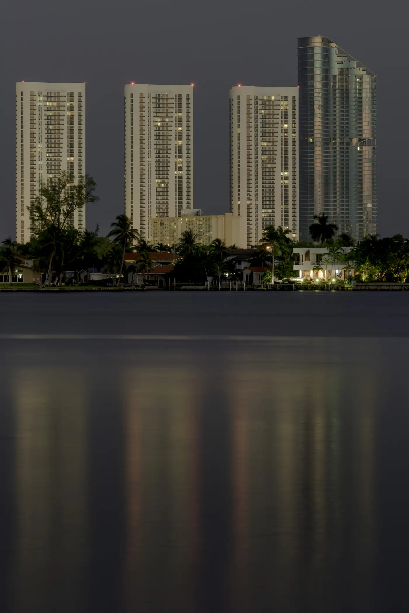 Collins Avenue towers reflected at night — Residences by Armani/Casa, Sunny Isles Beach