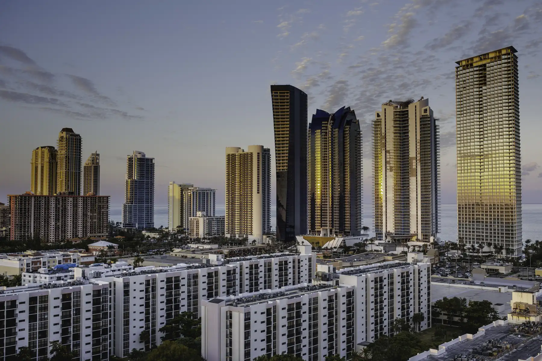 Central Sunny Isles towers at dusk, 2018 — the Jade towers, Muse, Ocean Four and Château Beach — Château Beach Residences, Sunny Isles Beach