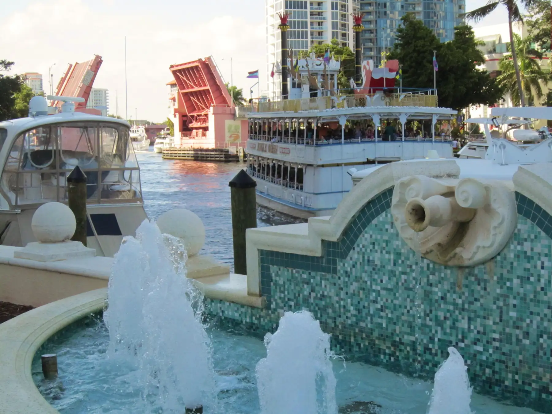 A fountain on the Riverwalk with a drawbridge raised on the New River