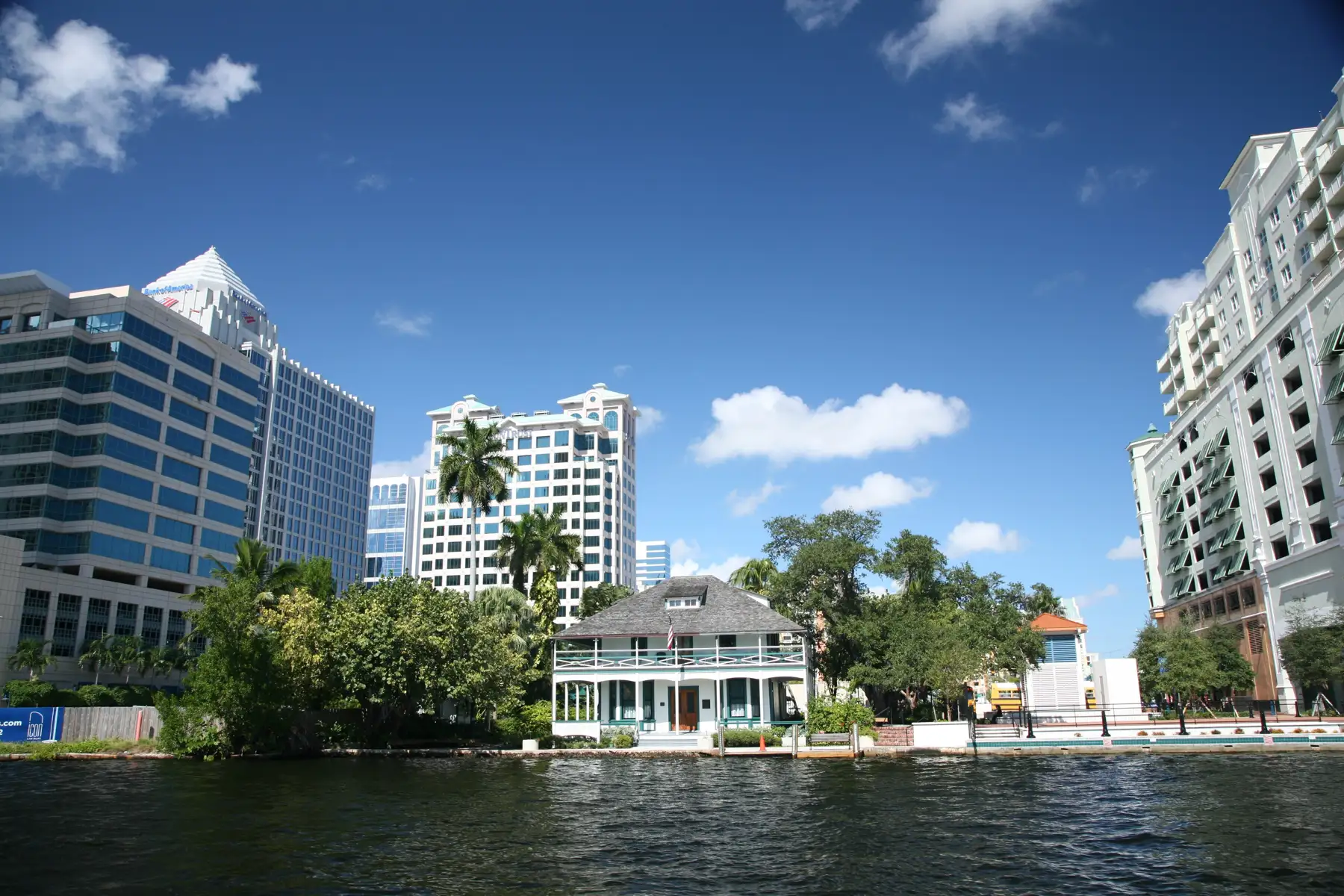 Stranahan House on the New River with downtown towers behind