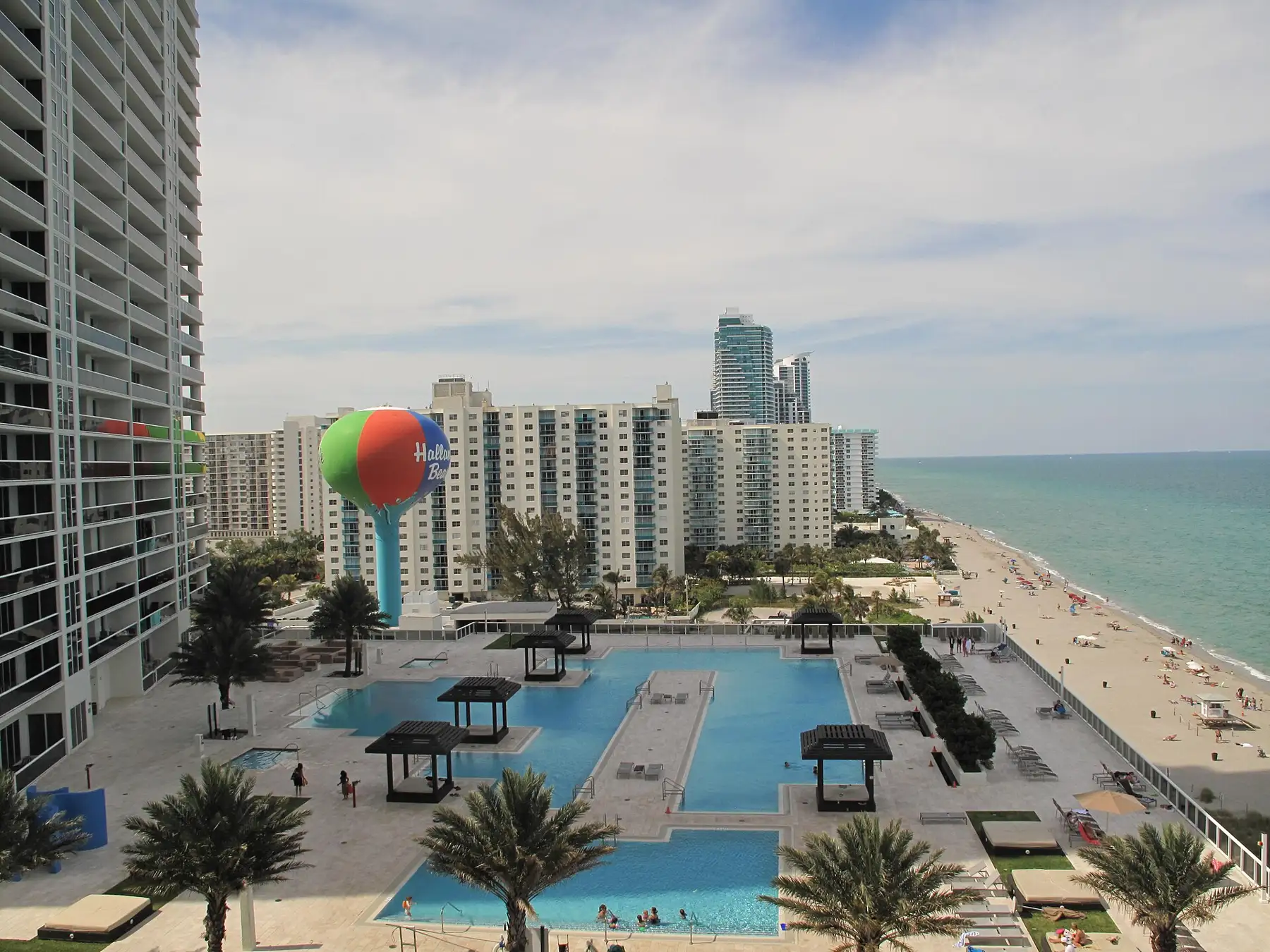 The beach-ball water tower and the South Ocean Drive row, seen from a neighboring tower — Parker Tower, Hallandale Beach