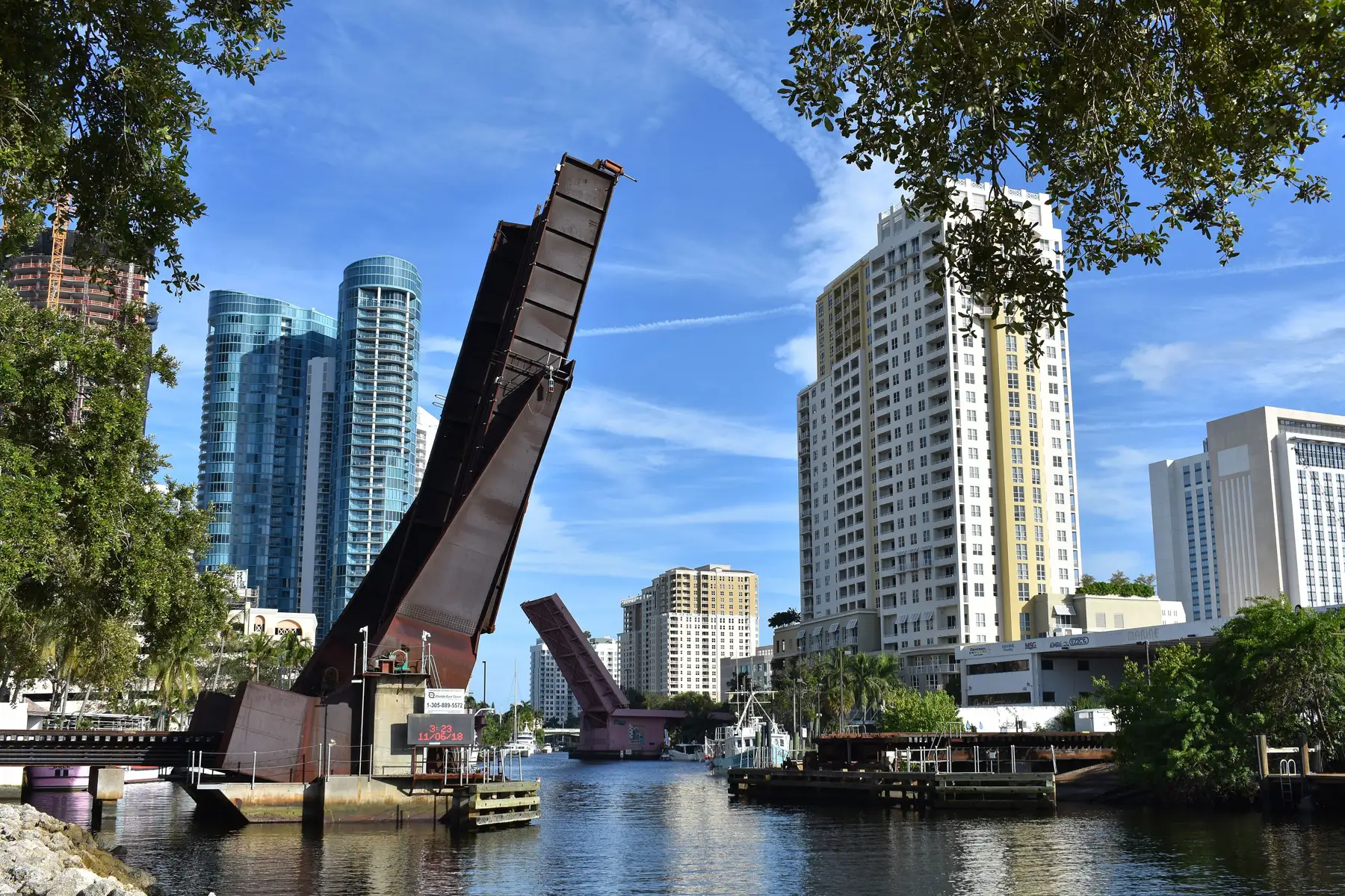 The railroad drawbridge raised on the New River; River House’s glass towers at left — Las Olas River House, Fort Lauderdale