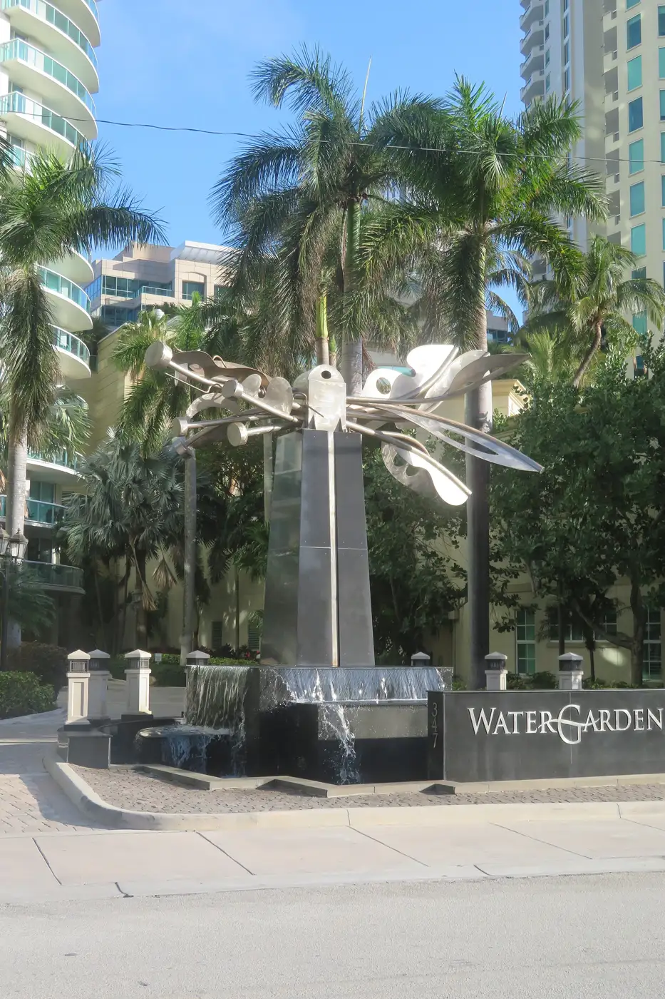 The Watergarden entrance on N New River Drive East with a stainless-steel sculpture over a fountain