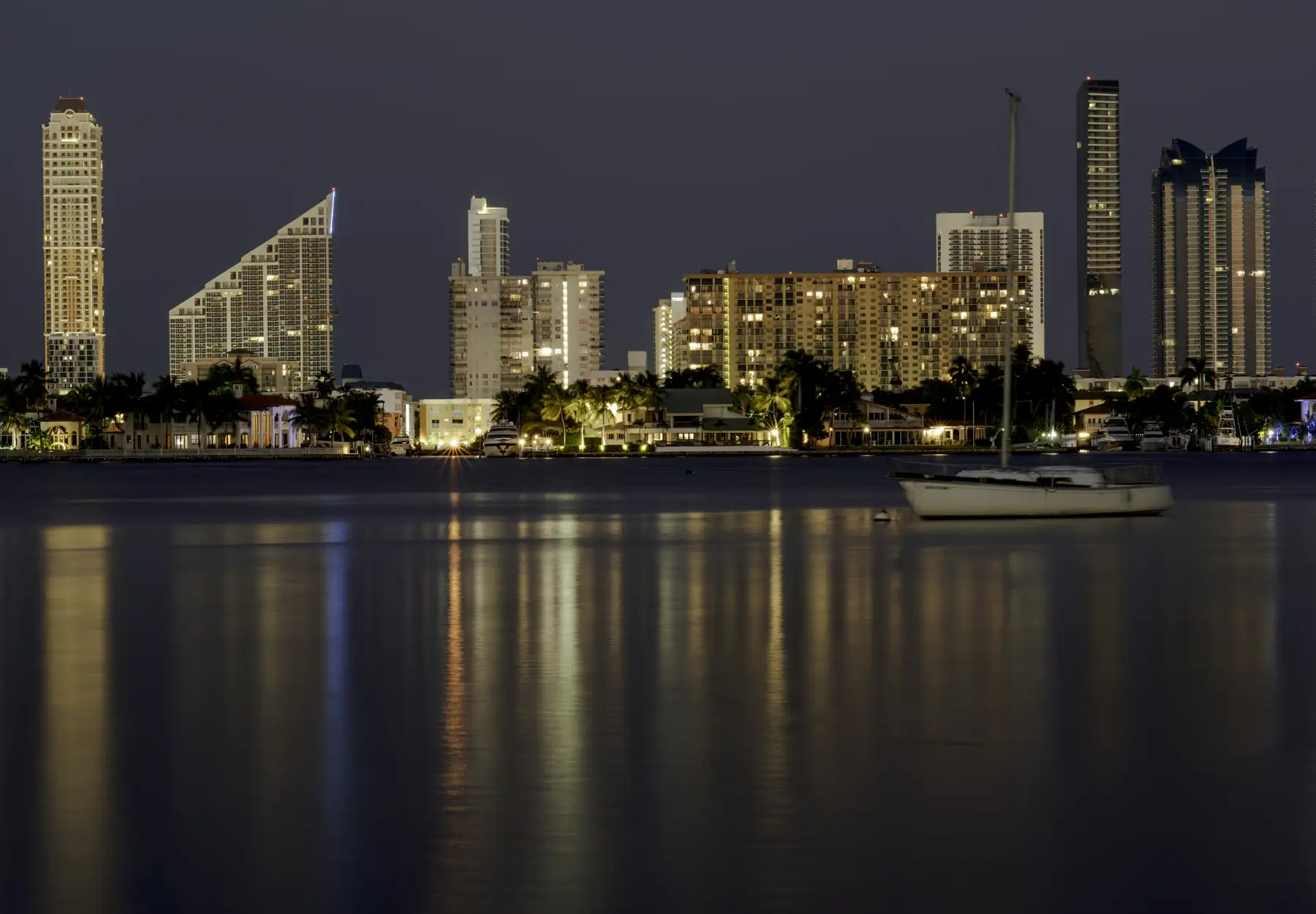 Sunny Isles towers across the water at night, 2019 — Winston Towers 600, Sunny Isles Beach